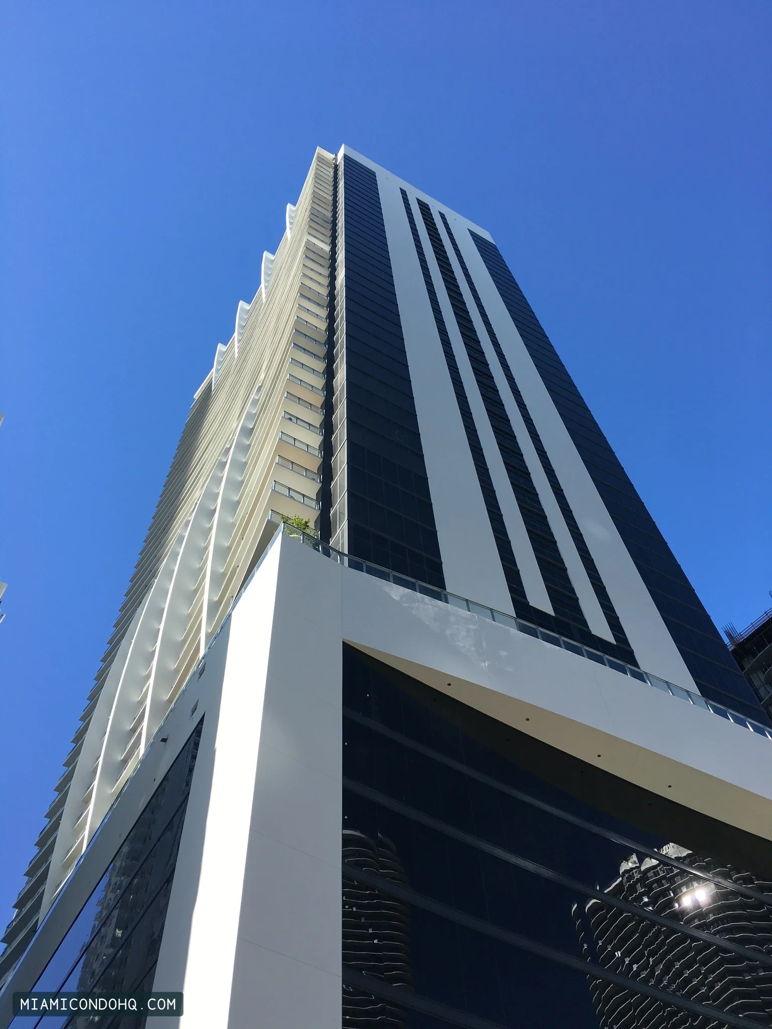 1010 Brickell’s completed tower and podium, photographed against a blue sky on March 22, 2018.