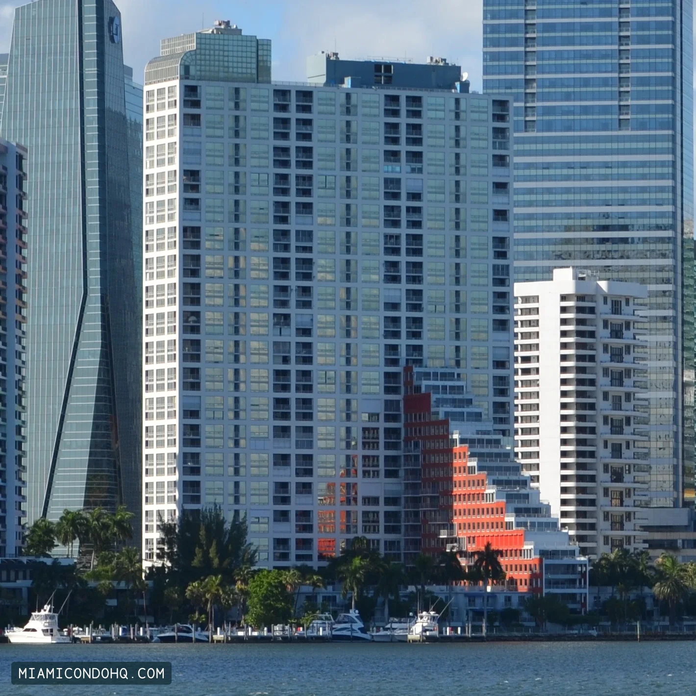 The Palace on Brickell’s waterfront, with its stepped red facade at lower right.